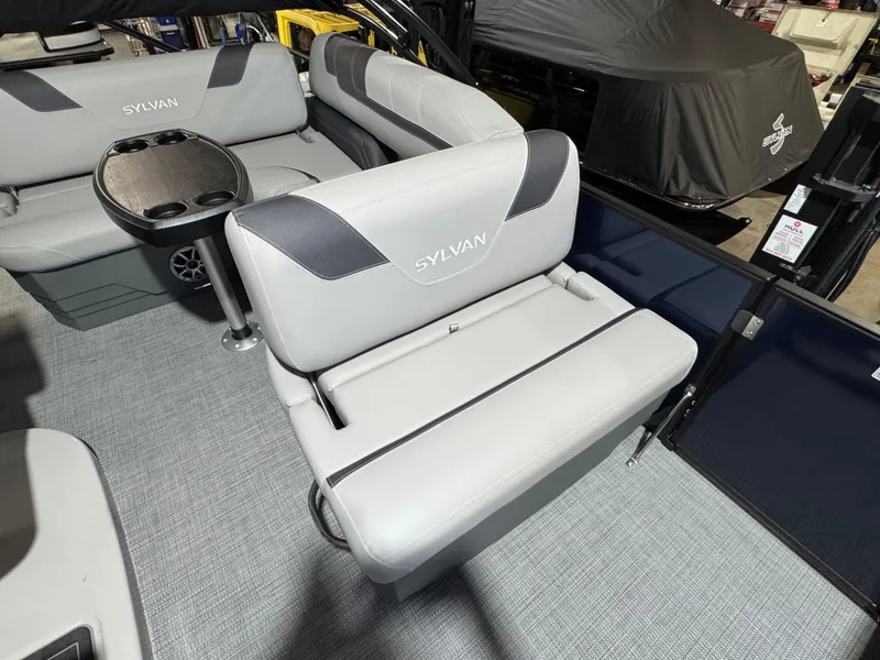Slide: The Image of 2025 Sylvan L3 CLZ boat interior with gray seating and a small table. - 7