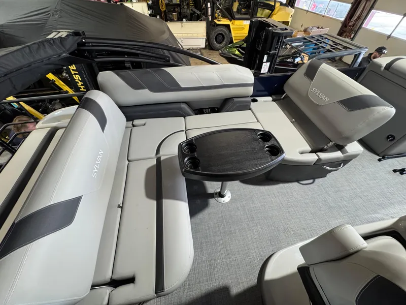 Slide: The Image of 2025 Sylvan L3 CLZ boat interior with gray seating and a central table. - 8