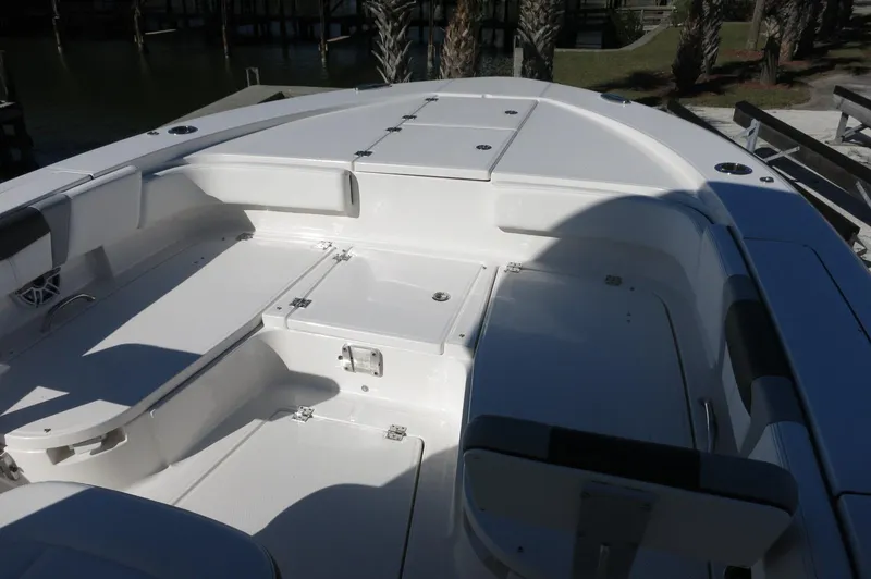 Slide: The Image of 2025 Robalo 266 Cayman boat deck with seating and storage compartments. - 14