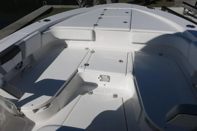 Slide: The Image of 2025 Robalo 266 Cayman boat interior with spacious seating and storage compartments. - 15