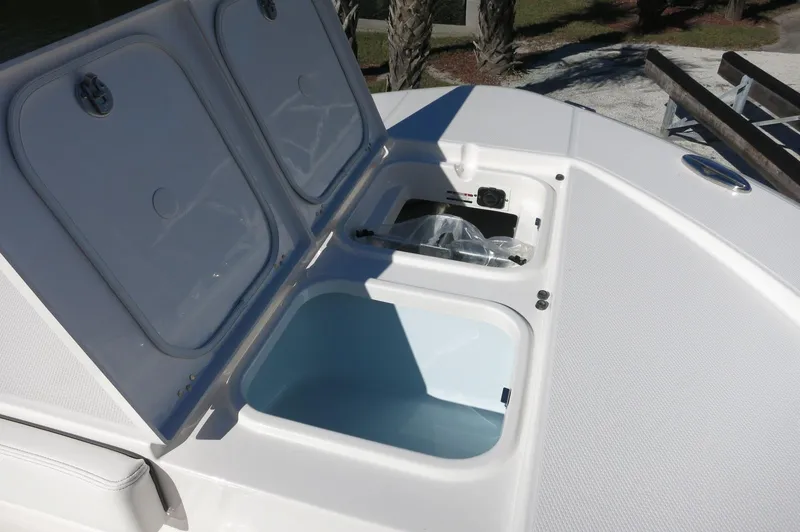 Slide: The Image of 2025 Robalo 266 Cayman boat storage compartments open on deck. - 16