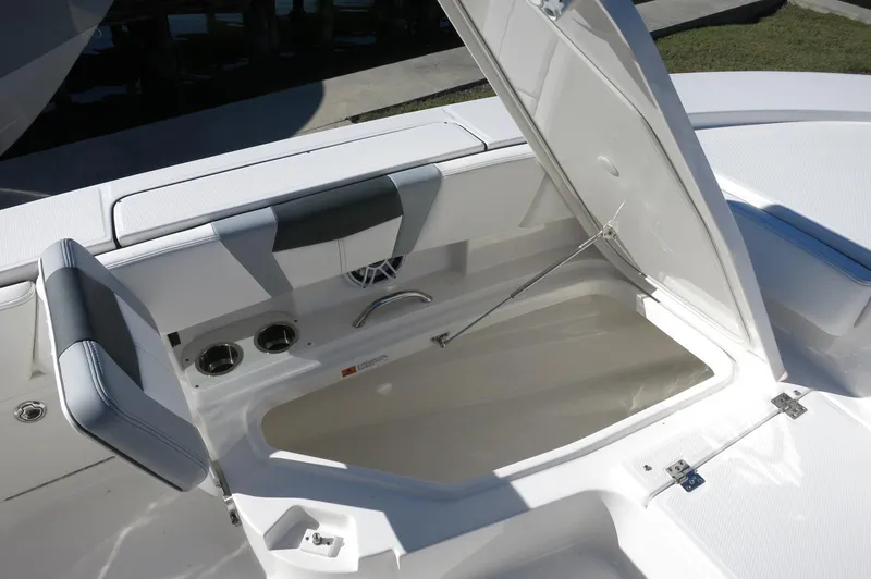 Slide: The Image of 2025 Robalo 266 Cayman boat with open storage compartment, showcasing sleek design and functionality. - 18