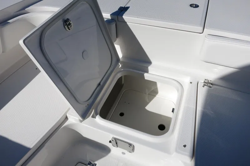 Slide: The Image of Open storage compartment on 2025 Robalo 266 Cayman boat, showcasing interior space. - 19