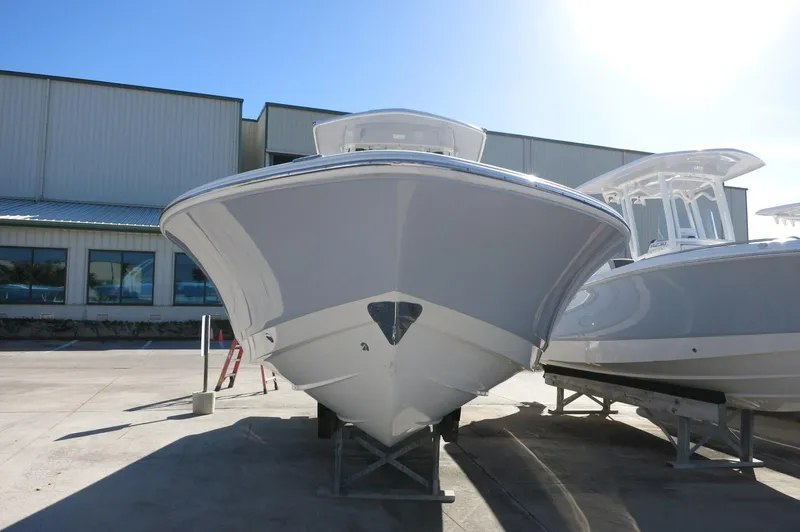 Slide: The Image of 2025 Robalo 266 Cayman boat on display in a marina setting. - 2