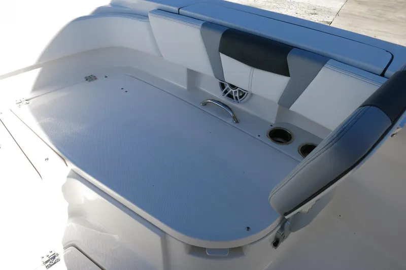 Slide: The Image of 2025 Robalo 266 Cayman boat seating area with cup holders and sleek design. - 20
