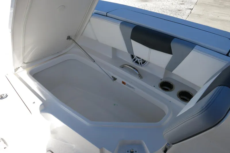 Slide: The Image of 2025 Robalo 266 Cayman boat interior with storage compartment and cup holders. - 21
