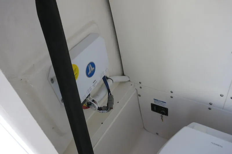 Slide: The Image of Interior view of 2025 Robalo 266 Cayman boat, showcasing electrical components and wiring. - 26