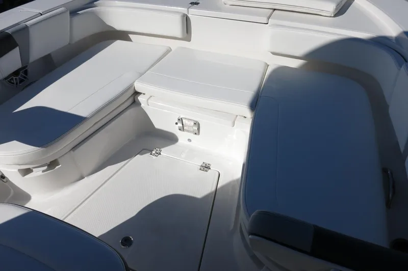 Slide: The Image of 2025 Robalo 266 Cayman boat interior with white cushioned seating. - 28