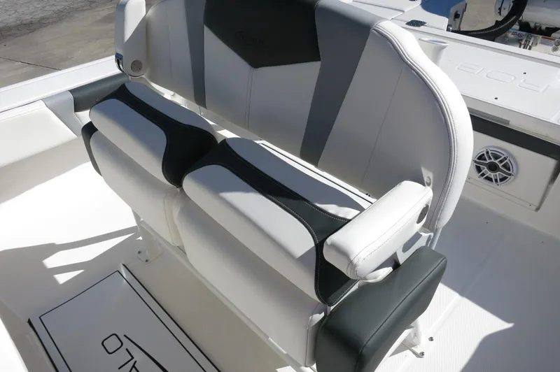 Slide: The Image of 2025 Robalo 266 Cayman boat seating with white and black cushioned design. - 31