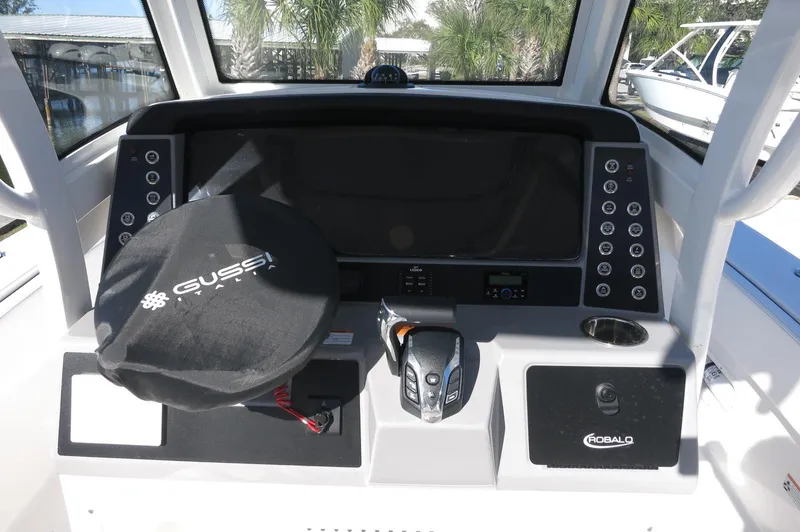 Slide: The Image of 2025 Robalo 266 Cayman boat dashboard with advanced controls and Gussi steering wheel cover. - 32