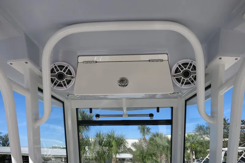 Slide: The Image of 2025 Robalo 266 Cayman boat interior with speakers and storage compartment. - 33