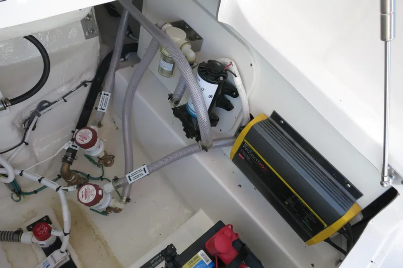 Slide: The Image of 2025 Robalo 266 Cayman boat interior showing electrical and plumbing components. - 37