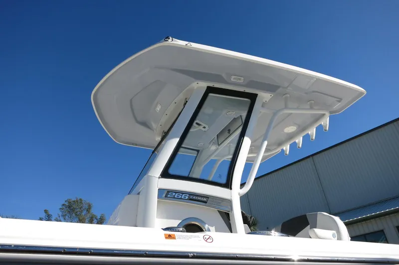 Slide: The Image of 2025 Robalo 266 Cayman boat with T-top against clear blue sky. - 4