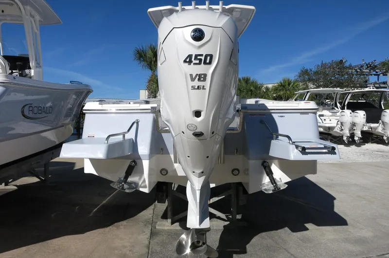 Slide: The Image of 2025 Robalo 266 Cayman boat with powerful 450 V8 5.6L engine, rear view. - 7