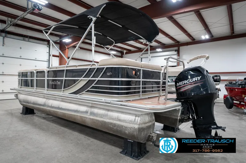 Slide: The Image of 2014 Bennington 522CR pontoon boat with Mercury outboard motor in a showroom. - 10