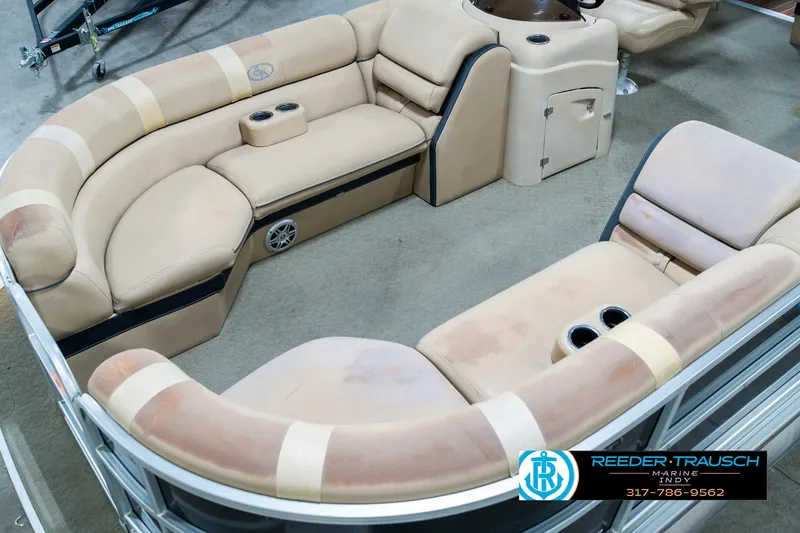 Slide: The Image of 2014 Bennington 522CR pontoon boat interior with beige seating and cup holders. - 12