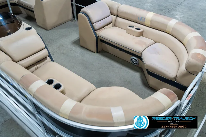 Slide: The Image of 2014 Bennington 522CR pontoon boat interior with beige seating and cup holders. - 13