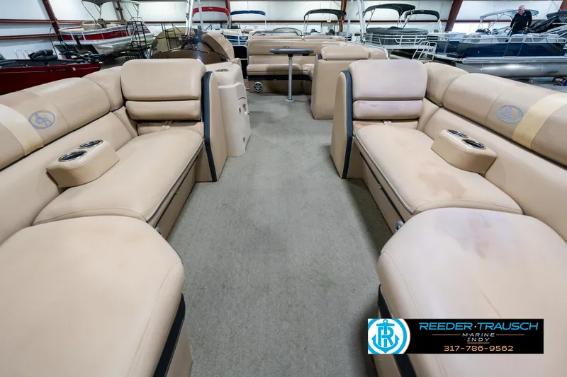 Slide: The Image of 2014 Bennington 522CR pontoon boat interior with beige seating and cup holders. - 16