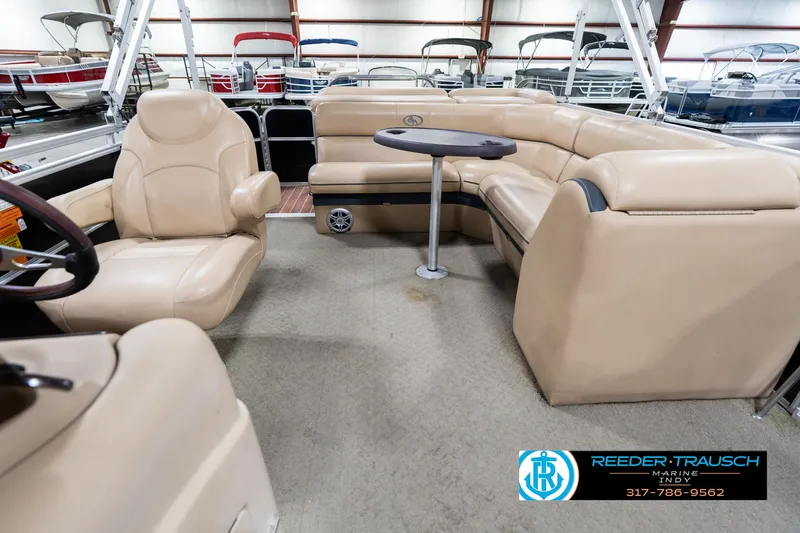 Slide: The Image of 2014 Bennington 522CR pontoon boat interior with beige seating and table. - 17