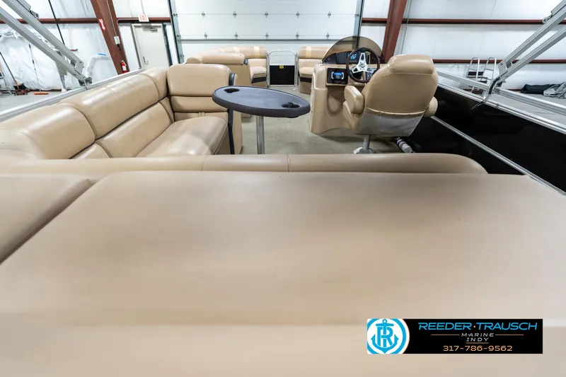 Slide: The Image of 2014 Bennington 522CR pontoon boat interior with beige seating and steering console. - 19