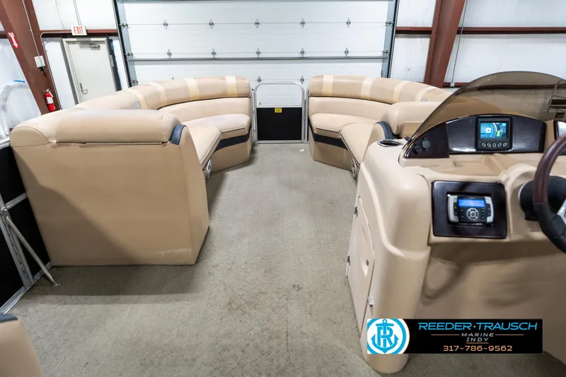 Slide: The Image of 2014 Bennington 522CR pontoon boat interior with beige seating and control panel. - 20
