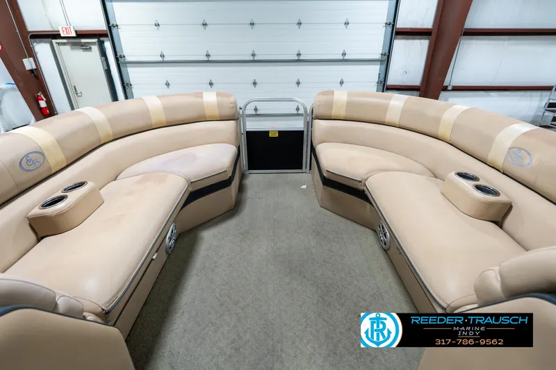 Slide: The Image of 2014 Bennington 522CR pontoon boat interior with beige seating and cup holders. - 21