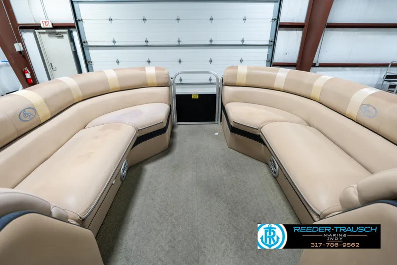 Slide: The Image of 2014 Bennington 522CR pontoon boat interior with beige seating in a garage setting. - 22