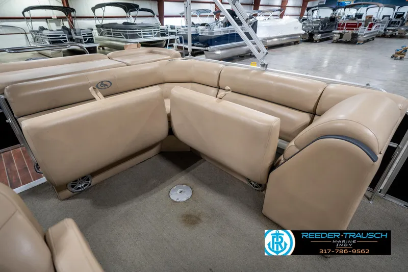 Slide: The Image of 2014 Bennington 522CR pontoon boat interior with beige seating in showroom. - 28