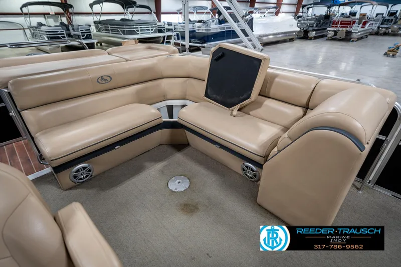 Slide: The Image of 2014 Bennington 522CR boat interior with beige seating in showroom. - 29
