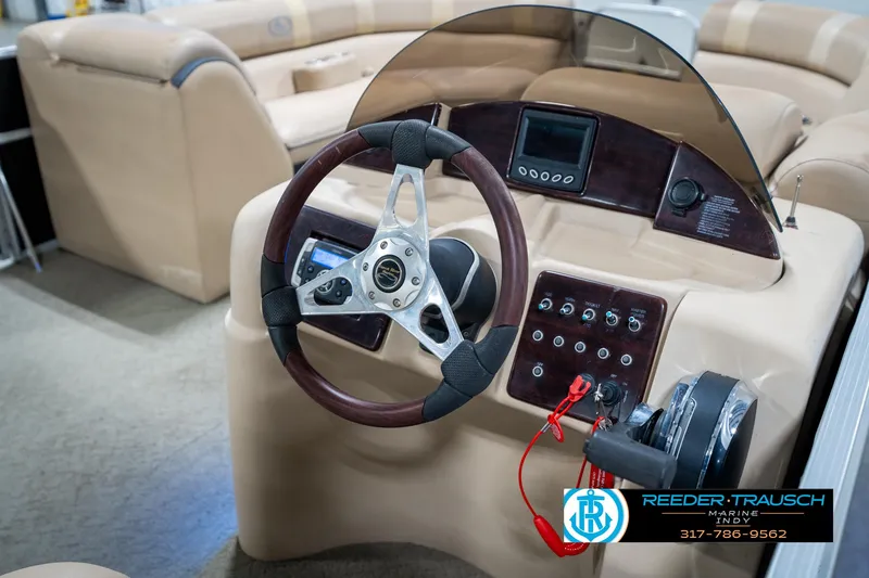 Slide: The Image of 2014 Bennington 522CR boat dashboard with steering wheel and control panel. - 34