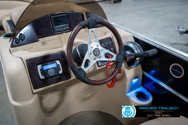 Slide: The Image of Steering console of a 2014 Bennington 522CR boat with modern controls and illuminated cup holder. - 35