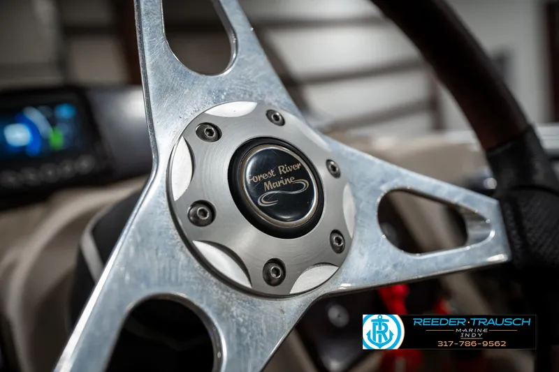 Slide: The Image of Steering wheel of a 2014 Bennington 522CR boat, featuring Forest River Marine logo. - 36