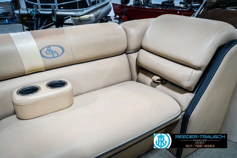 Slide: The Image of 2014 Bennington 522CR boat interior with beige leather seating and cup holders. - 42