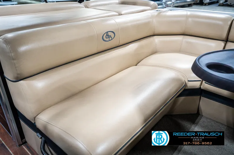 Slide: The Image of 2014 Bennington 522CR boat interior with beige leather seating and logo. - 43