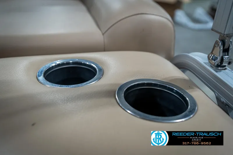 Slide: The Image of Cup holders on beige seating of a 2014 Bennington 522CR boat. - 47
