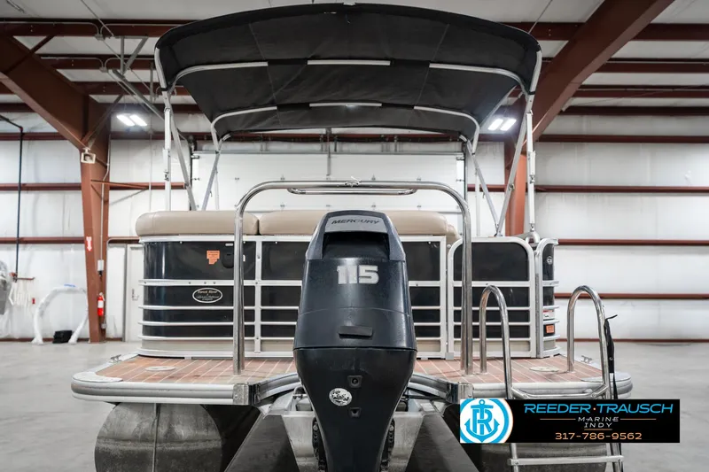 Slide: The Image of 2014 Bennington 522CR pontoon boat with 115 horsepower engine in indoor storage. - 9