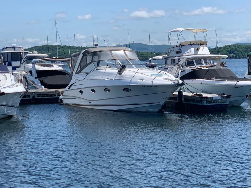 The Image of 2002 Doral 310se boat docked at marina with other vessels, under clear blue sky. - 0