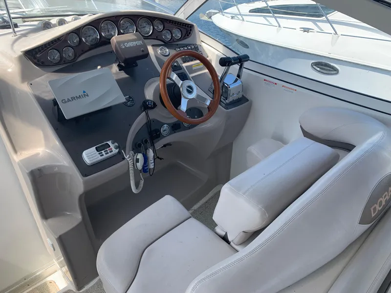 Slide: The Image of 2002 Doral 310se boat cockpit with Garmin navigation and leather seating. - 10