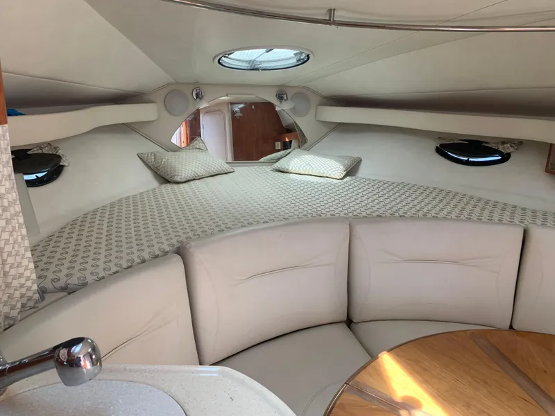 Slide: The Image of 2002 Doral 310se boat interior with cozy seating and bed area. - 17