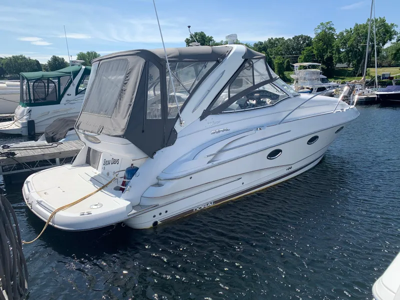 Slide: The Image of 2002 Doral 310se boat docked at marina on a sunny day. - 2