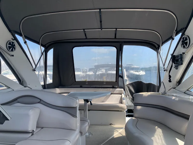 Slide: The Image of Interior view of 2002 Doral 310se boat with seating and table. - 24