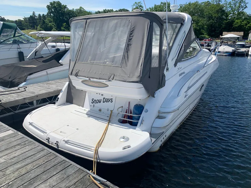 Slide: The Image of 2002 Doral 310se boat docked at marina, featuring "Snow Days" on the stern. - 3