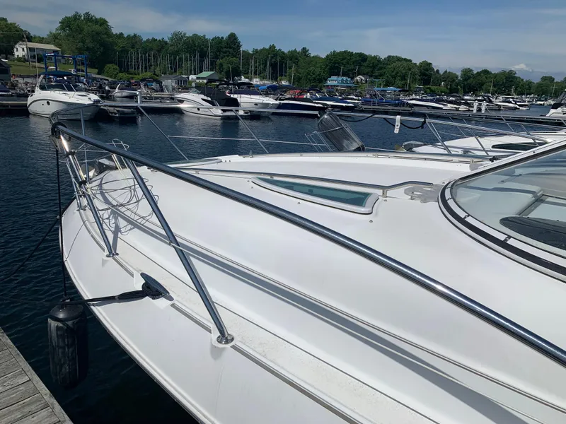 Slide: The Image of 2002 Doral 310se boat docked at marina with other vessels in background. - 5