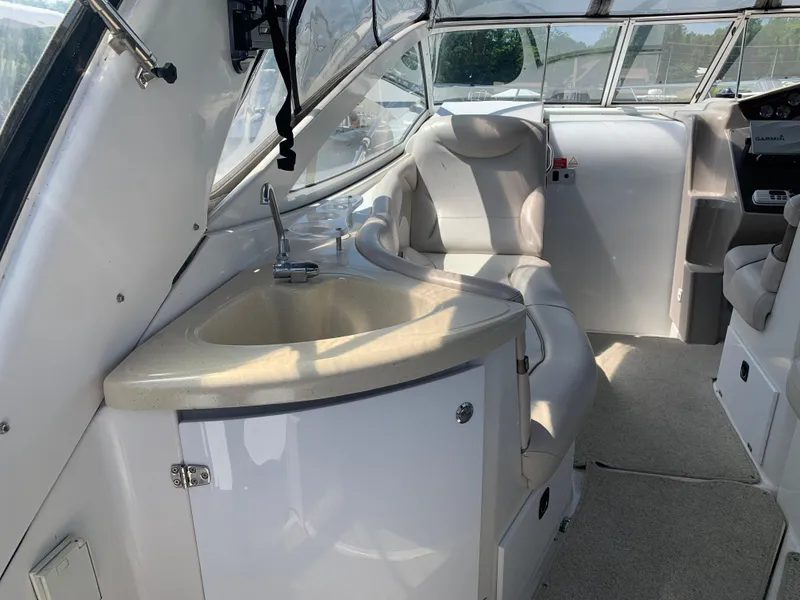 Slide: The Image of Interior of a 2002 Doral 310se boat with seating and a small sink. - 9
