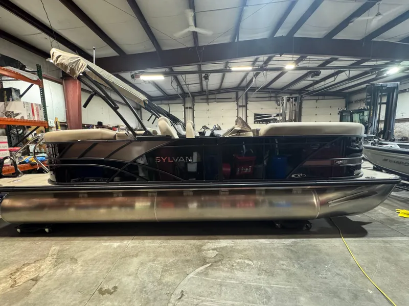 The Image of 2025 Sylvan Mirage X X3 pontoon boat in a warehouse setting. - 0