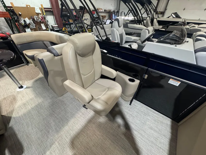 Slide: The Image of 2025 Sylvan Mirage X X3 pontoon boat interior with beige seating and modern design. - 7