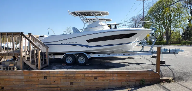 The Image of 2020 Jeanneau Leader 7.5 WA boat on trailer, parked outdoors, side view. - 0