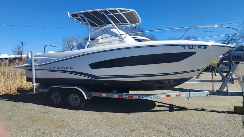 Slide: The Image of 2020 Jeanneau Leader 7.5 WA boat on trailer, side view, clear blue sky. - 11