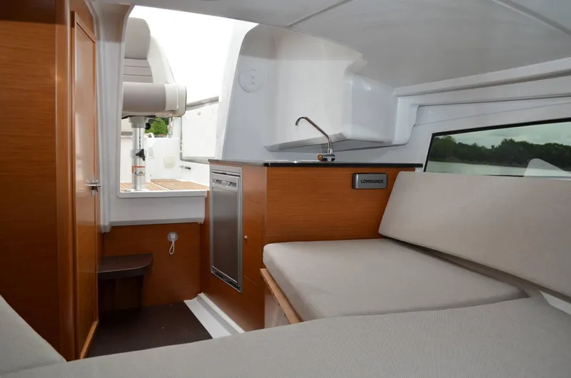 Slide: The Image of Interior of 2020 Jeanneau Leader 7.5 WA boat with seating and kitchenette. - 6