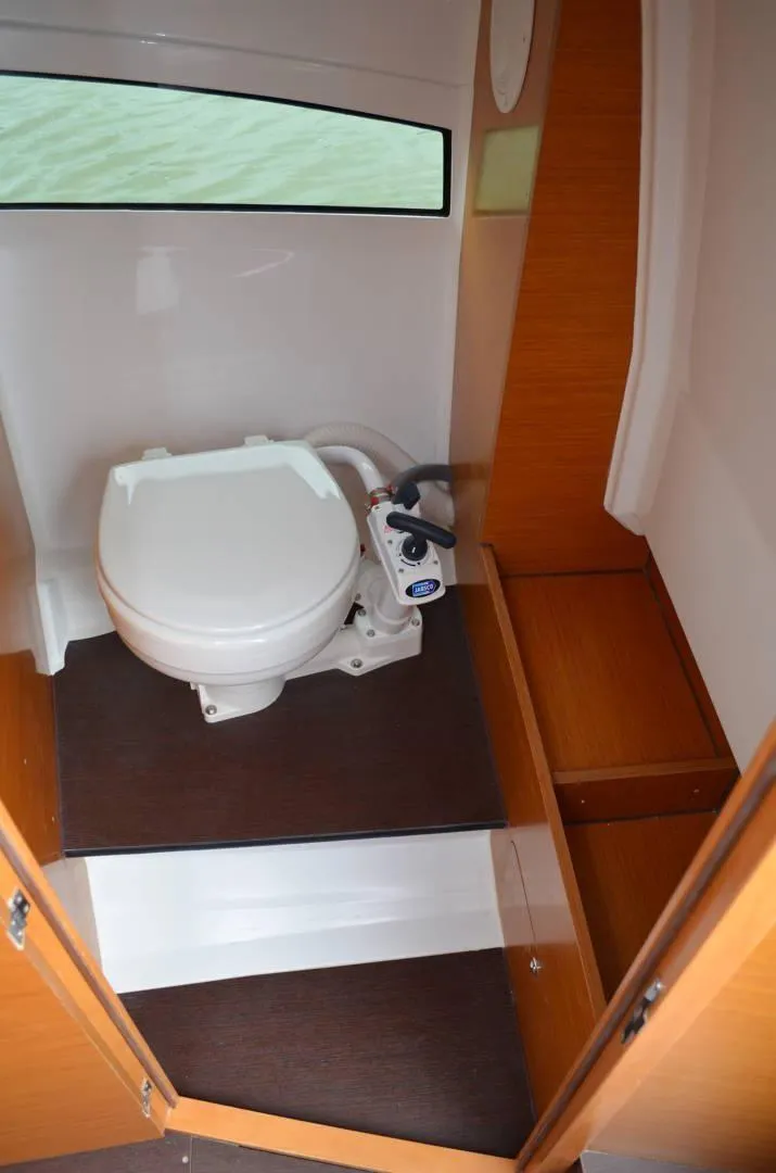 Slide: The Image of 2020 Jeanneau Leader 7.5 WA boat interior with compact marine toilet. - 8